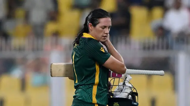 Tazmin Brits of South Africa walks off