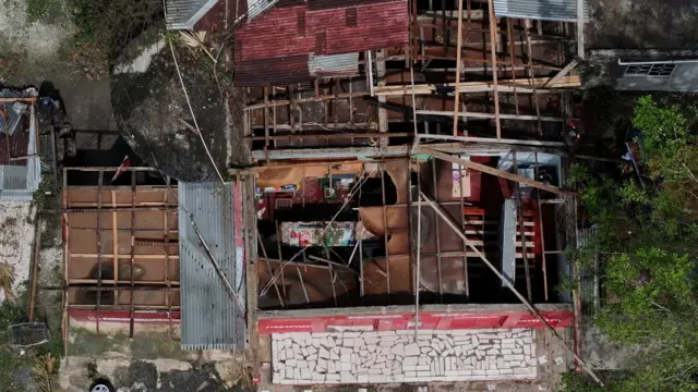 Drone view of a building with a ripped-out roof after Hurricane Melissa made landfall in St Elizabeth, Jamaica,