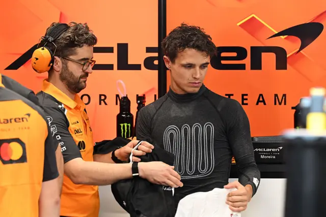 Lando Norris wears a cooling vest in the McLaren garage
