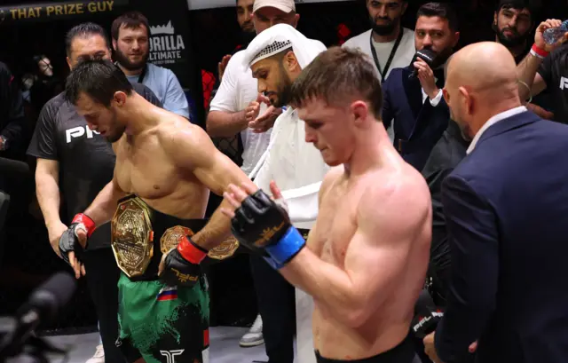 Usman Nurmagomedov has the belt wrapped around him