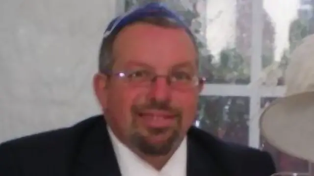 Melvin Cravitz in a black jacket and white shirt