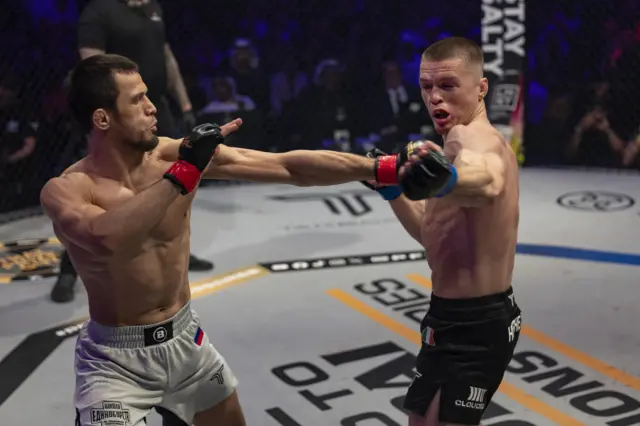 Usman Nurmagomedov connects with a left hook on Paul Hughes