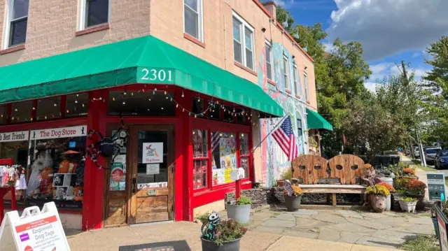 The frontage of a dog store in Alexandria, Virginia. A US flag is in the far right of the photo.
