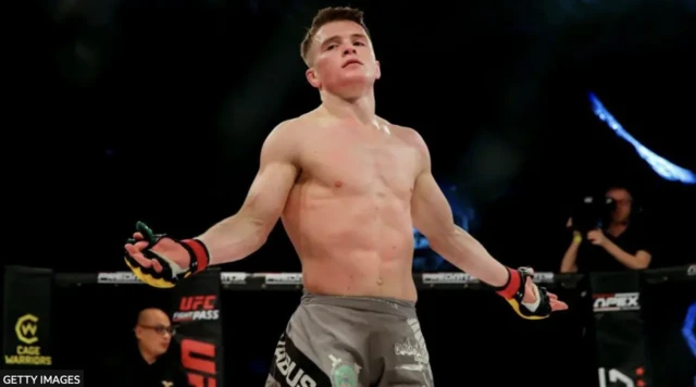 Paul Hughes with his arms out wide in October 2021
