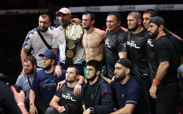 Usman Nurmagomedov and his team with the belt