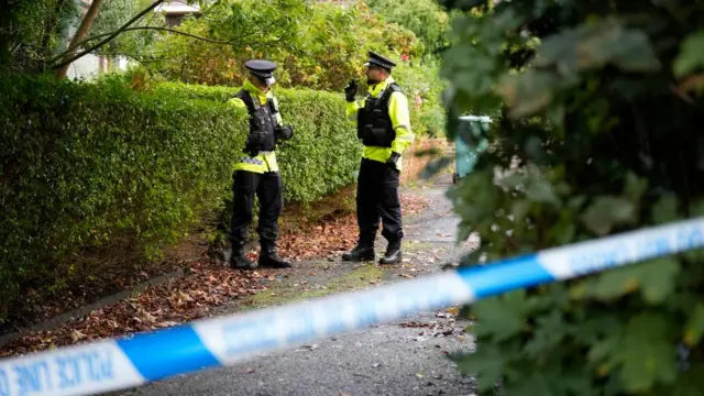 Police remain in place at a cordon in Prestwich