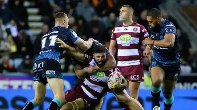 Wigan's Abbas Miski is tackled by Leigh