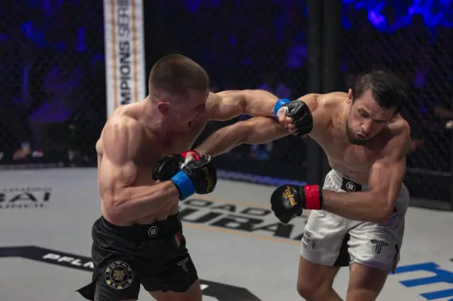 Paul Hughes lands a punch on Usman Nurmagomedov
