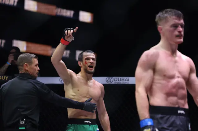 Usman Nurmagomedov celebrates with a cut on his eyebrow