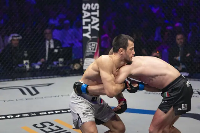 Usman Nurmagomedov and Paul Hughes grapple