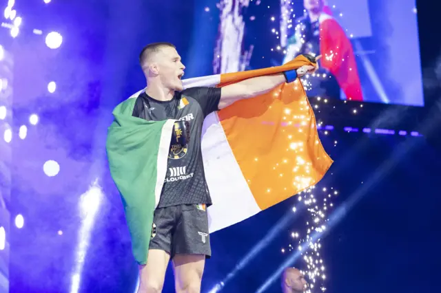 Paul Hughes walking out with the Ireland flag