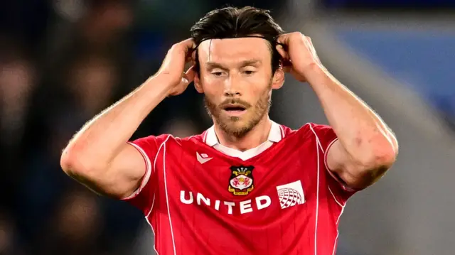 Wrexham AFC forward Kieffer Moore adjusts his headband during the EFL Sky Bet Championship match between Leicester City and Wrexham FC at the King Power Stadium, Leicester