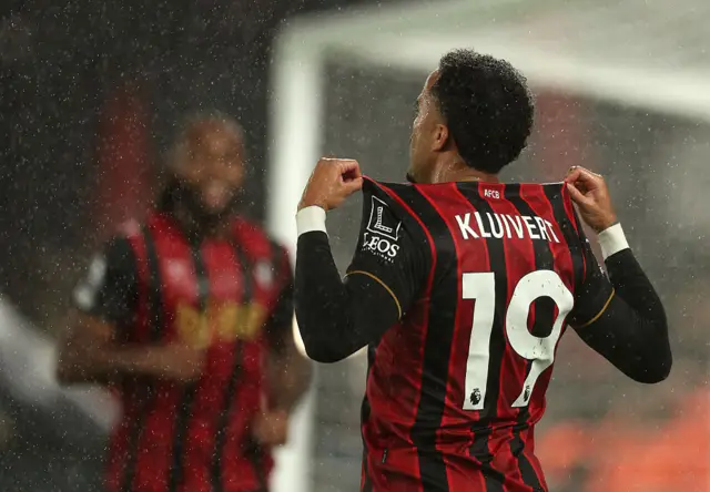 Kluivert holds up the name on the back of his shirt to the fans