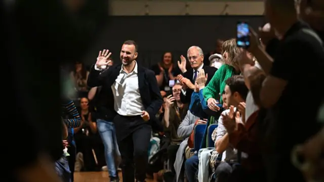 Zack Polanski jogs past Green Party members after giving his speech
