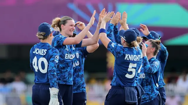Lauren Bell of England celebrates with team mates after taking the wicket of Sune Luus of South Africa