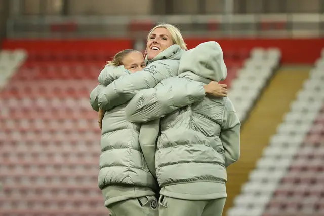Millie Bright of Chelsea embraces teammate Guro Reiten as they inspect the pitch prior to the Barclays Women's Super League match between Manchester United and Chelsea FC at Leigh Sports Village on October 03, 2025 in Leigh, England.