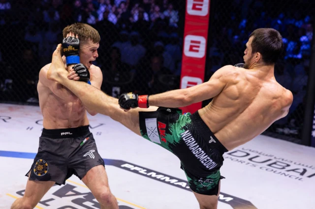 Nurmagomedov throws a kick at Hughes' head