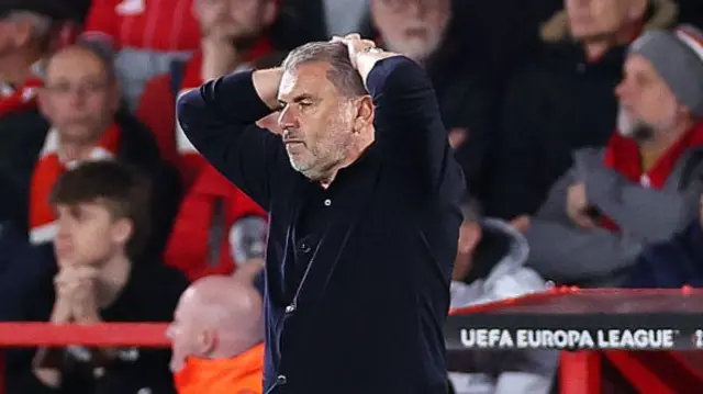 Ange Postecoglou puts his hand to his head