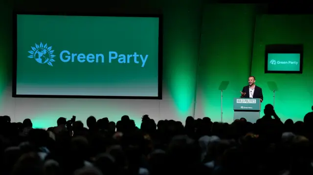 A green podium in front of a green stage