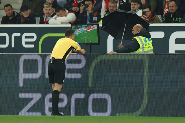 Referee Felix Zwayer checks the pitchside VAR monitor