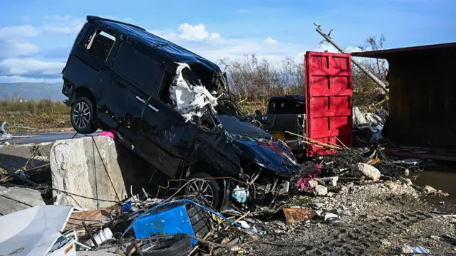 A car and surrounding buildings are seen damaged following the passage of Hurricane Melissa in St Elizabeth Jamaica.