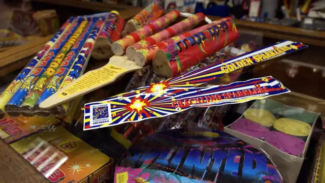 A range of brightly coloured fireworks on sale in a shop
