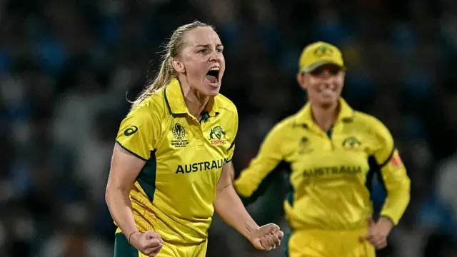 Australia's Kim Garth celebrates (L) after taking the wicket of India's Shafali Verma