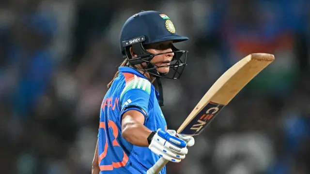 India's captain Harmanpreet Kaur celebrates after scoring a half-century (50 runs)