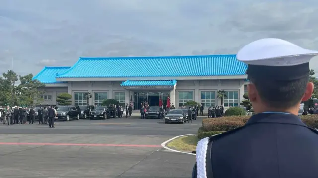 A one-story building with a blue roof