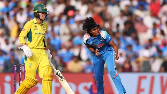 Sree Charani of India bowls as Phoebe Litchfield of Australia looks on