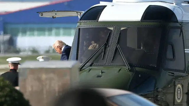 Trump alighting from Marine One after landing at Gimhae International Airport