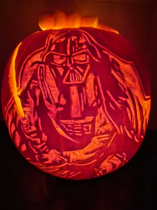 A carved pumpkin with a Star Wars design.