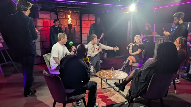 Presenters discuss at a roundtable in Live Lounge