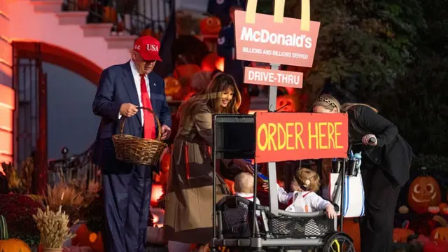 Donald Trump holds basket at White House next to McDonald's sign