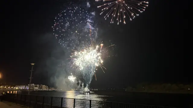 Fireworks ignite over the water