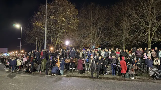 People line the streets