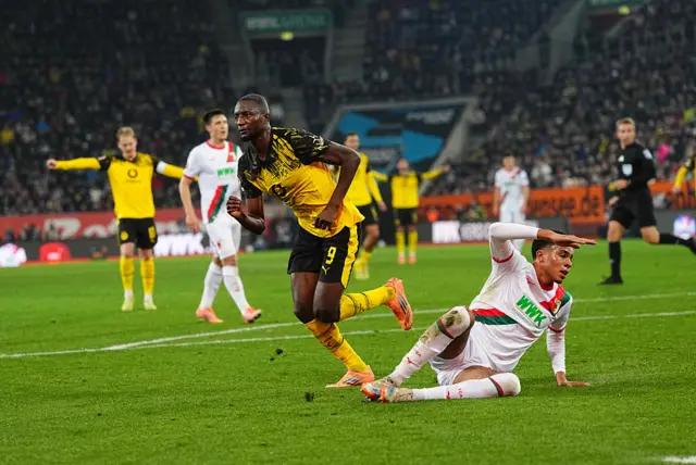 Serhou Guirassy wheels off to celebrate opening the scoring for Borussia Dortmund against Augsburg.