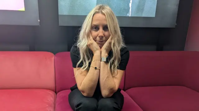 Charlie Hedges sitting on a sofa