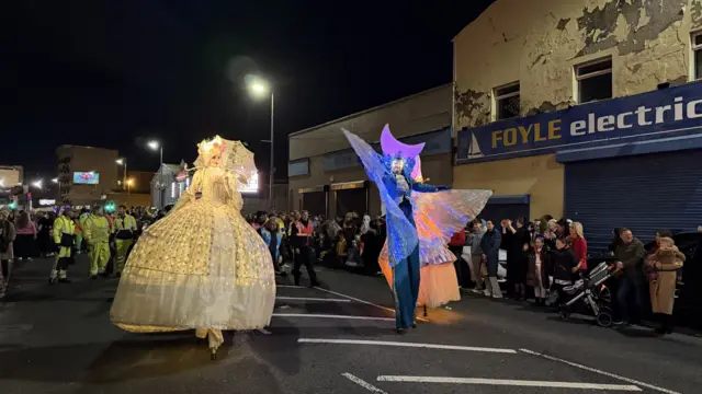 A large inflatable fairy and wizard in the parade