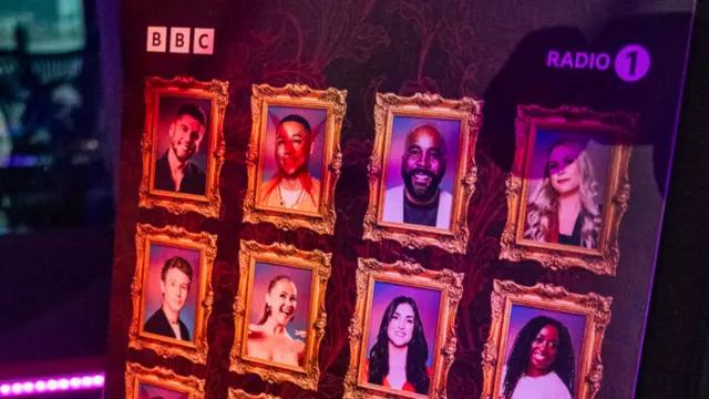 A board with Radio 1 contestants' faces.