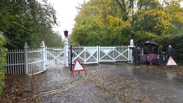 Members of the press gather outside gates of Royal Lodge