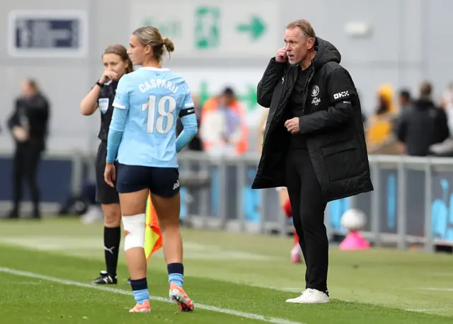 Andree Jeglertz, Manager of Manchester City, interacts with Kerstin Casparij of Manchester City during the Barclays Women's Super League match between Manchester City and Arsenal at Joie Stadium on October 04, 2025 in Manchester, England.