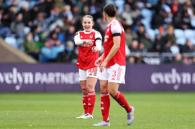 Kim Little of Arsenal interacts with teammate Lotte Wubben-Moy during the Barclays Women's Super League match between Manchester City and Arsenal at Joie Stadium on October 04, 2025 in Manchester, England.