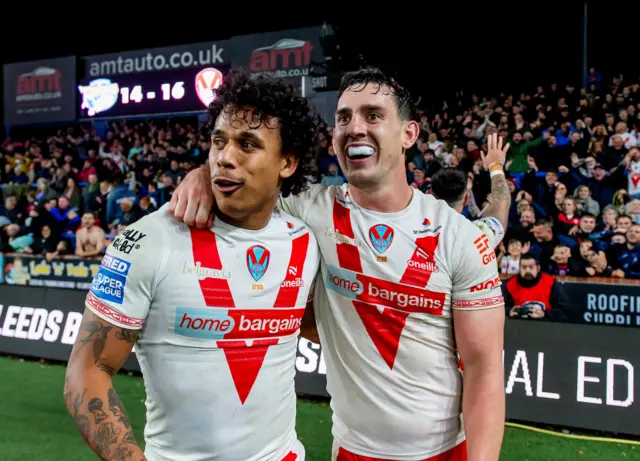 Tristan Sailor and Matt Whitley (right) celebrate St Helens' win at Leeds in the play-offs