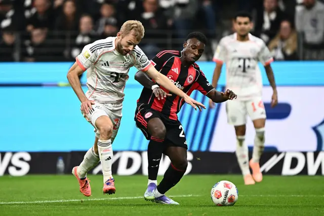 Konrad Laimer of Bayern Munich and Buta of Eintracht Frankfurt battle for possession