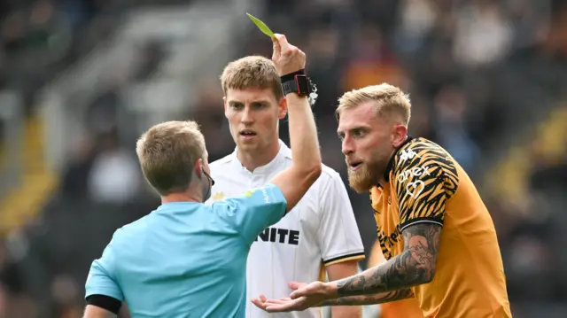 Oliver McBurnie of Hull City (right) protests to the referee