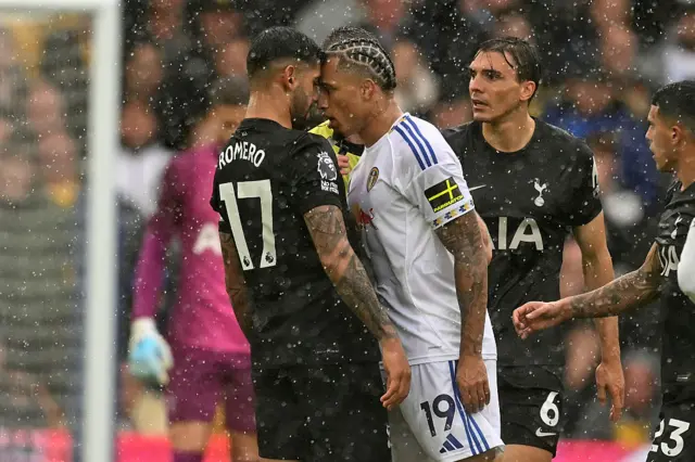Cristian Romero (L) clahes with Leeds United's Swiss striker #19 Noah Okaford
