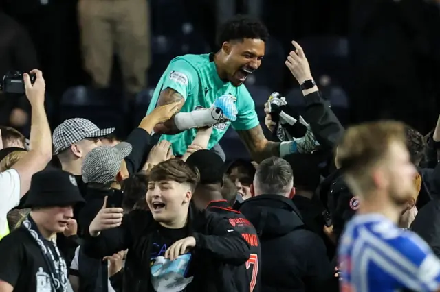 St Mirren goalkeeper Shamal George celebrates with fans after the penalty shootout victory