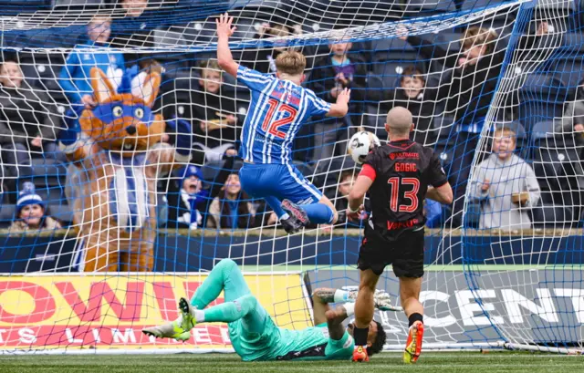 Captain Conker (beponchoed) enjoys David Watson's goal