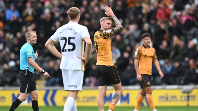 Oliver McBurnie of Hull City applauds the fans after being substituted
